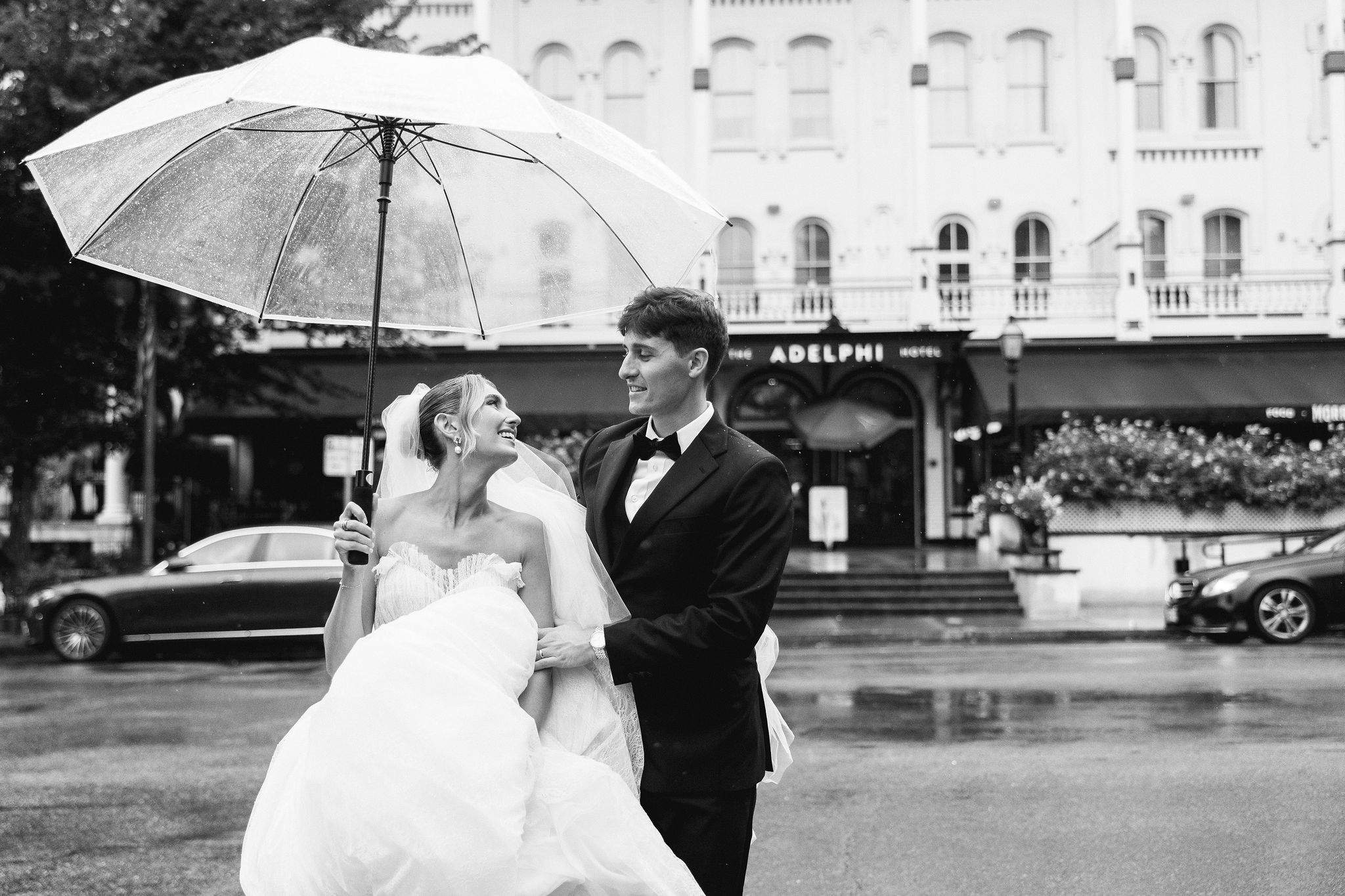 candid photo of bride and groom on Broadway in saratoga Springs, NY