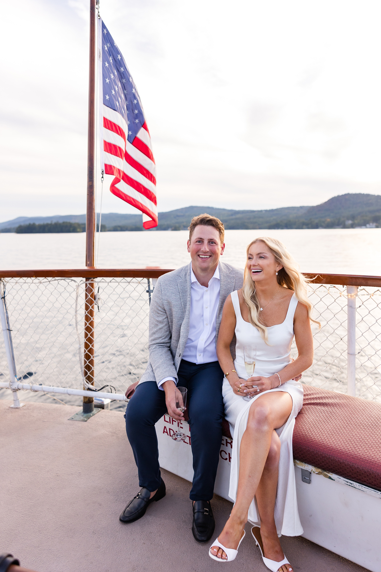 Bride and groom share a candid moment on Lake George at The Sagamore