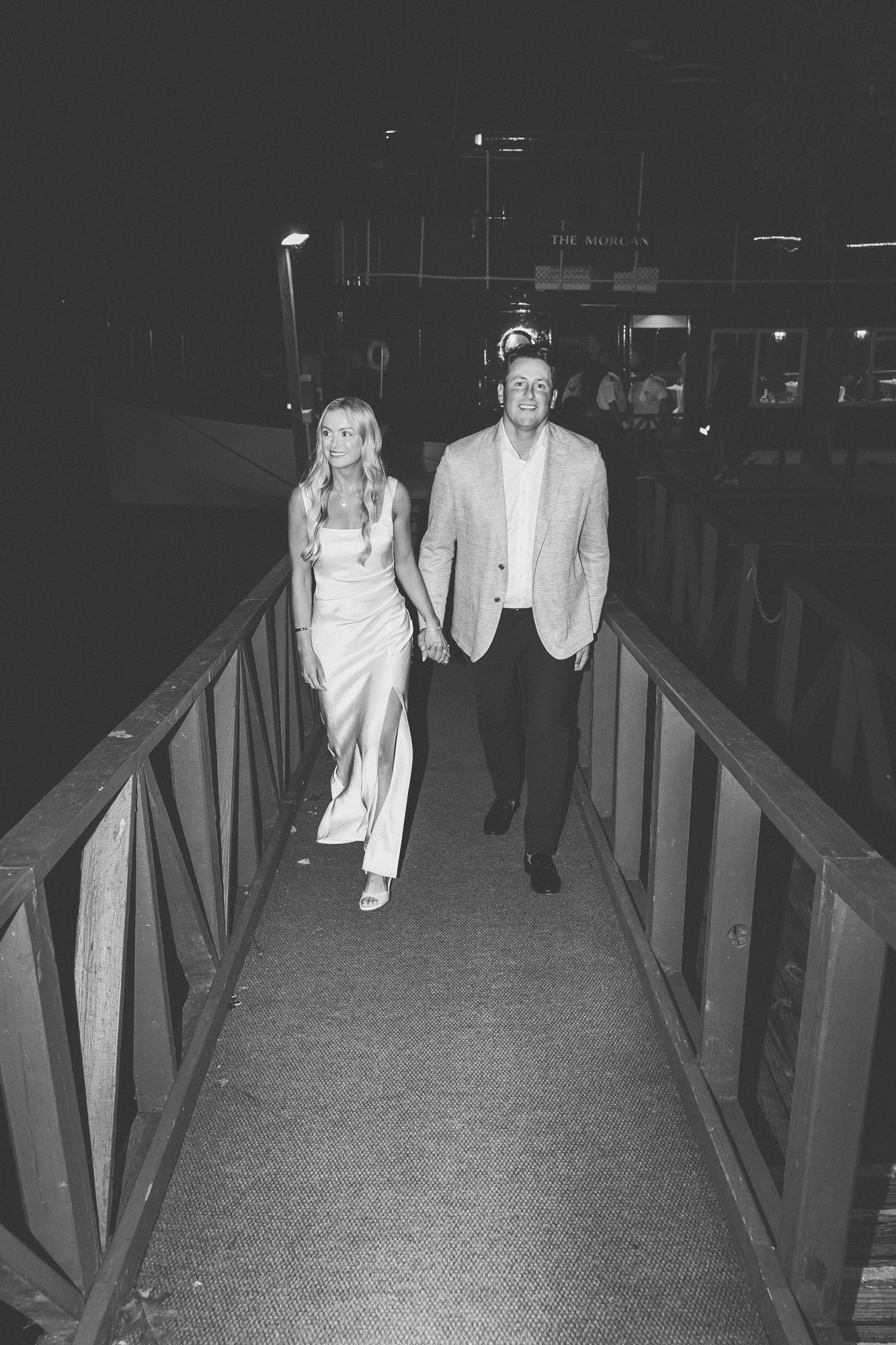 the bride and groom walk off The Morgan Boat at the sagamore in lake george, ny