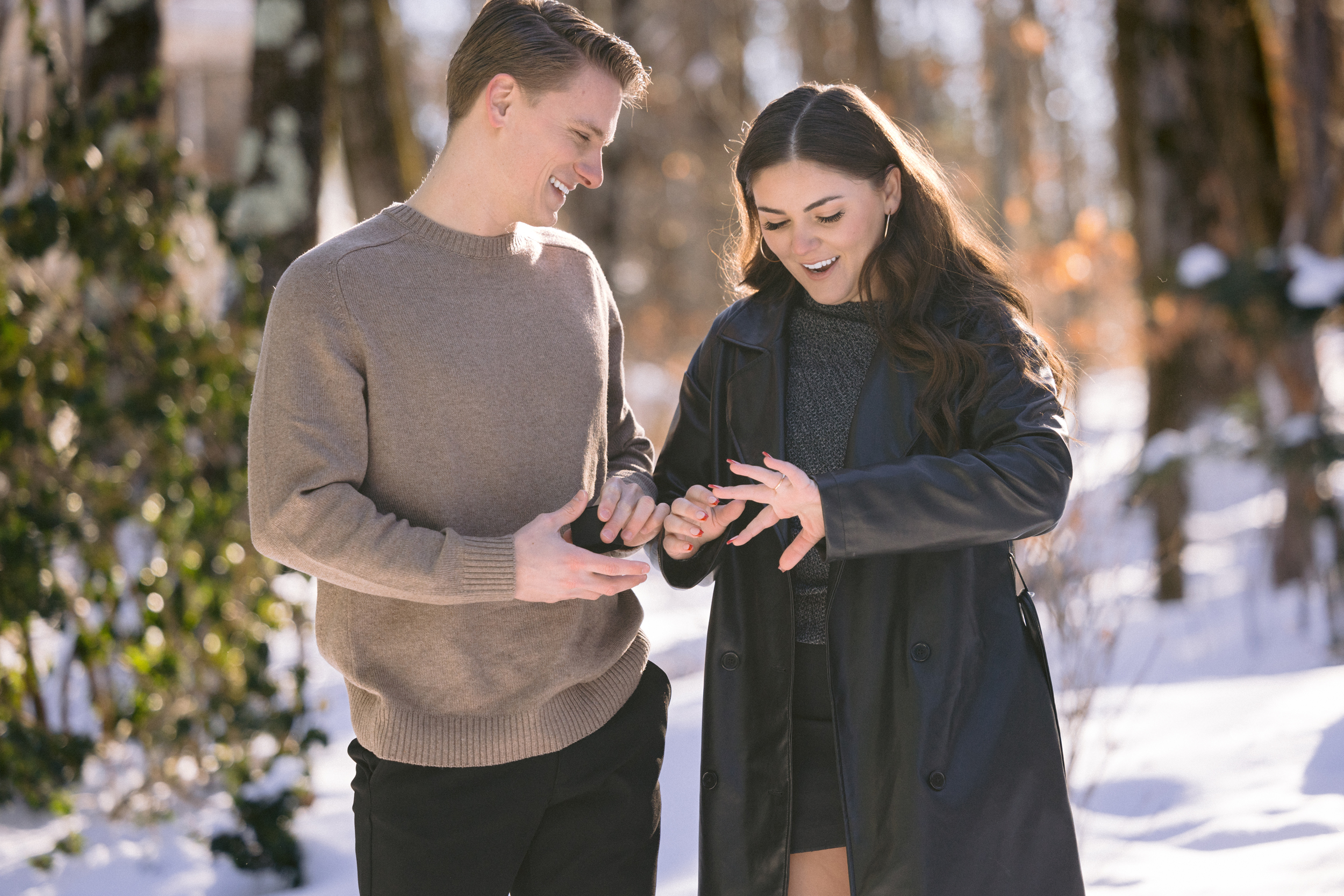 Happy fiance looks at her new engagement ring in Lake George NY